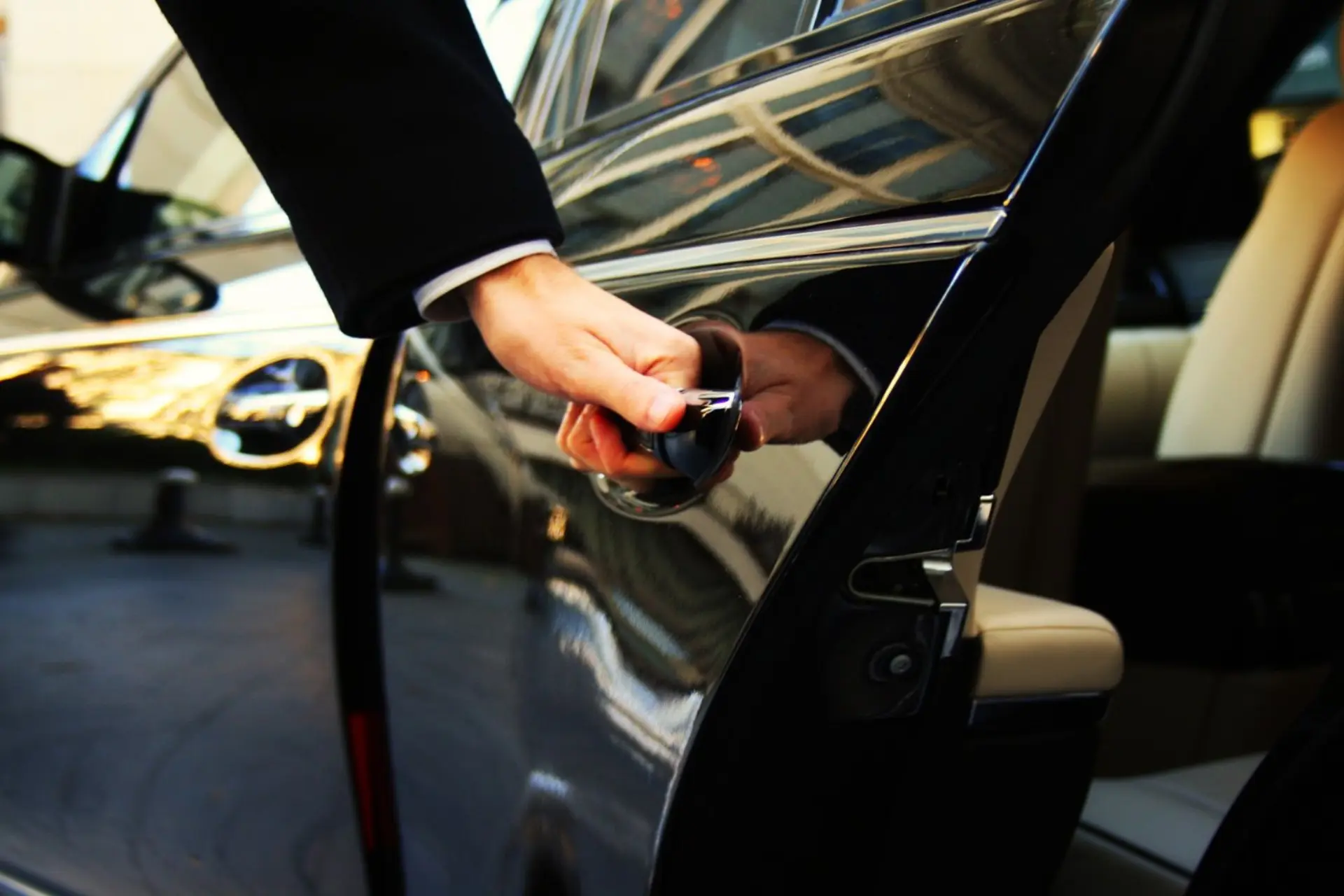 Professional chauffeur opening car door — Four Winds Transportation Services Albuquerque Sunport transfers